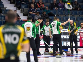 Team Saskatchewan celebrates after a great shot against Northern Ontario during Tuesday's morning draw at the Brier.