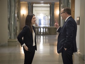 Alison White, chair of the Government Affairs and Advocacy Committee with the Student Medical Society of Saskatchewan, left, speaks with Health Minister Jim Reiter in a hallway at the Legislative Building in Regina.