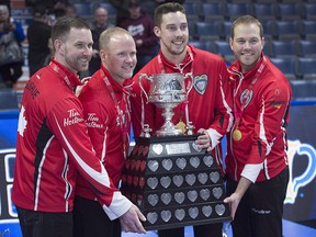 Team Canada skip Brad Gushue, third Mark Nichols, second Brett Gallant and lead Geoff Walker, left to right, pose with the Brier Tankard after defeating Alberta to win the Tim Hortons Brier at the Brandt Centre in Regina on Sunday, March 11, 2018. (THE CANADIAN PRESS/Andrew Vaughan)