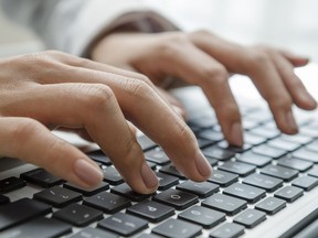 Closeup female hands typing on keyboard