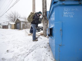 Terance Grady, the founder of Saskatoon Cares, explores the ground around dumpers for used needles to collect in the alleys near the Salvation Army in Saskatoon, SK on Thursday, April 5, 2018.