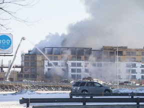 Saskatoon firefighters work to put out a structure fire at the corner of Lorne Avenue and Circle Drive in Saskatoon, SK on Wednesday, April 18, 2018.