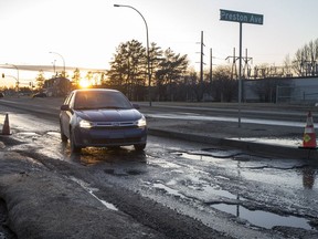 Motorists attempt to navigate a large collection of potholes on 108th Street near the intersection with Preston Avenue in Saskatoon, SK on Thursday, April 19, 2018.