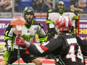 Saskatchewan Rush defenceman Kyle Rubisch  (4) challenges Calgary Roughnecks forward Dane Dobbie  (44)  during first quarter action in Saskatoon, SK on Saturday, April 28, 2018.