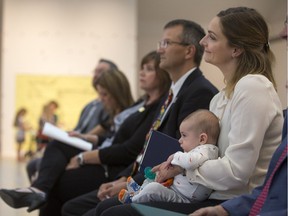 Coun. Mairin Loewen, right, with her son, Asa, listen during a media event to announce federal funding for the Children's Discovery Museum on the Saskatchewan at the former Mendel Art Gallery building in Saskatoon on Sept. 12, 2017