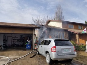 Saskatoon Fire Department crews respond to a fire involving two homes and a car in the 200 block of Keeley Crescent on April 29, 2018. (Saskatoon Fire Department Photo)