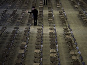Volunteers help set up chairs on April 7, 2018, for a vigil in the Elgar Petersen Arena in Humboldt.