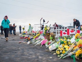 People pay their respects to the Humboldt Broncos at a memorial, located at the bus-crash site 28 kilometres south of Nipawin.