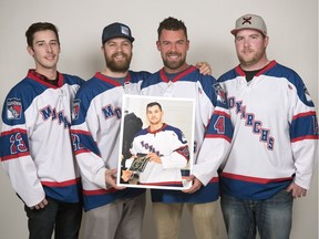 Members of the Lumsden Monarchs hockey team (from left) Josh Beaudry, Brady Aulie, Jake Latimer and Chris Whitteron pose with a photo of their former teammate Mark Cross in Regina. Cross was one of the 16 people killed in the Humboldt Broncos bus crash.