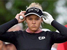 Brooke Henderson adjusts her visor at the first hole during the 2017 CP Women's Open of the LPGA Tour, in Ottawa on Thursday, Aug. 24, 2017. Henderson is just three wins away from becoming the most decorated Canadian professional golfer of all time -- and she's only 20 years old.