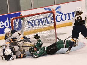 Grace Shirley of the Saskatoon Stars is upended by Kiah Vail (2) as she drives the net. Camryn Drever (29) makes the save during 2018 Esso Cup action in Bridgewater, N.S..