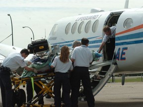 Regina EMS and Saskatchewan Air Ambulance personnel load up a patient in Lifeguard1 . This is the first patient from the Regina Qu'Appelle Health Region to be taken out of the province for medical care due to an impending Health Sciences Association of Saskatchewan (HSAS) strike. The patient and air ambulance crew arrived in Minot, ND shortly before 4pm and then went onto Minneapolis, St. Paul on Thursday June 28,2007.