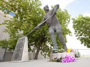 Flowers have been left at a statue of Gordie Howe at the Sasktel Centre in Saskatoon, Friday, June 10, 2016.