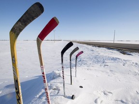 Hockey sticks to remember members of the Humboldt are seen standing in a snowbank along a stretch of highway 6 in Saskatchewan, Friday, April, 13, 2018. An accident involving a transport truck and a bus carrying the Humboldt Broncos hockey team left 16 dead and send over a dozen more to hospital.
