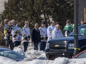 People lead out the casket of Dayna Brons, athletic trainer of the Humboldt Broncos, following a memorial service in Humboldt, Sask. Wednesday, April 18, 2018.