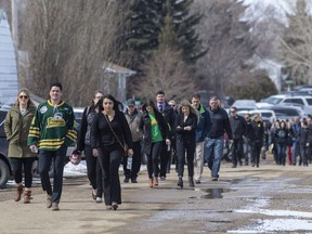 Community members enter the memorial service on April 15, 2018, in Allan, Sask., for Logan Schatz, captain of the Humboldt Broncos, who was one of 16 people killed in a bus crash on April 6, 2018.