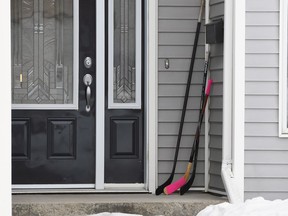 Hockey sticks sit on the front porch of a house in Humboldt, Sask., on Monday, April 9, 2018.