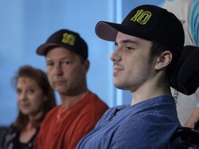 Humboldt Broncos hockey player Ryan Straschnitzki, who was paralyzed following a bus crash that killed 16 people, speaks to the media as his father Tom, centre, and as his mother Michelle, look on in Calgary, Alta., Wednesday, April 25, 2018.THE CANADIAN PRESS/Jeff McIntosh ORG XMIT: JMC108