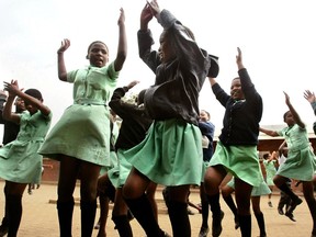 In their crisp uniforms, girls dance in a primary school courtyard in South Africa in this file photo.