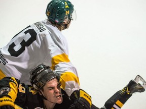 The Nipawin Hawks' Jordan Simoneau, top, lays a hit on the Estevan Bruins' Hayden Guilderson during Game 1 of the SJHL's championship series Saturday at Centennial Arena.