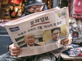 A man reads the Munhwa Ilbo newspaper featuring U.S. President Donald Trump and North Korean leader Kim Jong-un in Seoul, South Korea, on March 9, 2018.