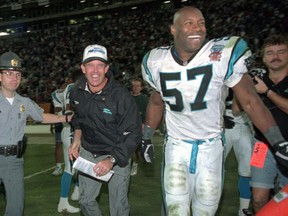 FILE - In this Oct. 15, 1995, file photo, Carolina Panthers head coach Dom Capers, center, and linebacker Lamar Lathon (57) celebrate the team's first win, 26-15 over the New York Jets at Memorial Stadium in Clemson, S.C. Carolina went 7-9 in their inaugural season in 1995 with Kerry Collins leading the way. The Panthers made it to the NFC championship game a season later, losing 30-13 to Brett Favre and the Green Bay Packers.