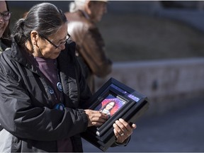 SASKATOON,SK--APRIL 23/2018-0424 News - Lucille Littlecrow, the mother of Beverly Littlecrow, holds a photograph of her daughter outside the Court of Queen's Bench in Saskatoon, SK on Monday, April 23, 2018. A manslaughter trial is underway where Gabriel Joseph Faucher (not pictured) is accused of killing his 36-year-old girlfriend, Beverly Littlecrow.
