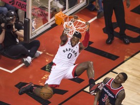 Toronto Raptors forward C.J. Miles dunks in front of Washington Wizards guard Bradley Beal on April 17.