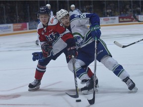 Tanner Nagel of the Swift Current Broncos tries to go wide on Lethbridge Hurricanes defenceman Calen Addison during Game 1 of the WHL's Eastern Conference final on Friday.