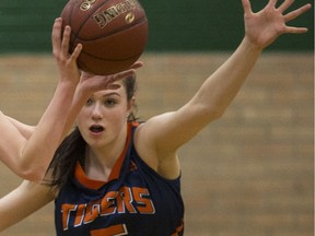 SASKATOON,SK--FEBRUARY 01/2017-0202 Sports High School Girls Basketball- Aden Bowman Bears Haley Poier, left, looks to pass the ball past Tommy Douglas Colligate Tigers Tori Hanson during first quarter Senior Girls Basketball action at Aden Bowman in Saskatoon, SK on Wednesday, February 1, 2017.