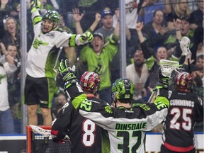 Saskatchewan Rush forward Matthew Dinsdale (32) and Saskatchewan Rush teammate Jeff Shattler (77) celebrate Shattler's goal against the Calgary Roughnecks during NLL action in Saskatoon on Saturday, April 28, 2018.