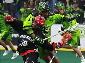 Saskatchewan Rush's Jeff Cornwall takes down Calgary Roughnecks' Dane Dobbie during a one-game, sudden-death playoff game at SaskTel Centre in Saskatoon, Sask. on May 10, 2018.