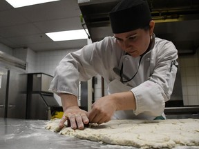 Chef Noelle Mark cuts out dough for savoury scones on Thursday, May 17th in preparation for the Delta Bessborough's royal wedding slumber party.