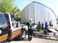 A team of workers and volunteers raises the Shakespeare on the Saskatchewan tent on the morning of Wednesday, May 23, 2018.