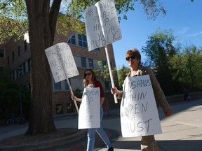 Cannabis dispensary supporter Suzanne Casastonguay (right) pickets outside of City Hall Monday morning in Saskatoon.