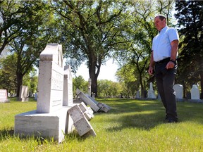 City of Saskatoon parks director Darren Crilly examines toppled headstones in Woodlawn Cemetery.
