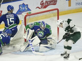 Martin Fasko-Rudas of the Everett Silvertips tries to knock the puck past Swift Current Broncos goalie Stuart Skinner during Game 5 of the WHL championship series on Friday. Photo by Robert Murray/WHL.
