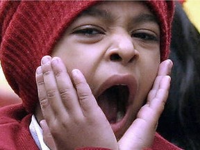 A child in New Delhi yawns.