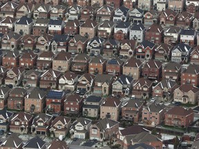 Aerial view of houses in Oshawa, Ont., seen from a Canadian forces Hercules on Saturday, Nov. 11, 2017. The Canadian Real Estate Association says national home sales sank to the lowest level in more than five years, falling by 13.9 per cent year-over-year in April.
