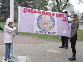 In this file photo from 2016, members of the Prince Albert Right to Life Association display the Celebrate Life Week flag that caused controversy over the city's community flagpole policy. (Prince Albert Daily Herald file photo)