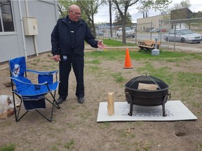 Regina fire marshal Randy Ryba demonstrates fire pit safety at the Regina Fire Headquarters on May 17, 2018.