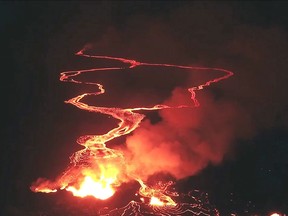 This May 22, 2018 photo from video from an unpiloted aircraft provided by the U.S. Geological Survey, shows flow from what scientists call fissure 22 as lava from Kilauea Volcano continues to flow into the ocean, top, near the town of Pahoa, Hawaii. (U.S. Geological Survey via AP) ORG XMIT: LA514