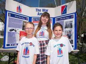 From left, Connor Broley, Angeline Ducharme and Tristin Ellis stand in front of the War Amps booth during the Highland Games taking place at Victoria Park.