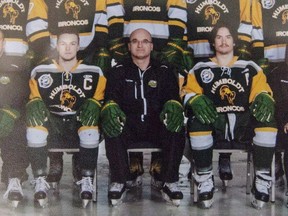 Head coach and general manager Darcy Haugan, centre, is shown in team photo of the 2016/2017 Humboldt Broncos hockey team as it hangs in Elgar Petersen Arena in Humboldt, Sask., on Saturday, April 7, 2018.