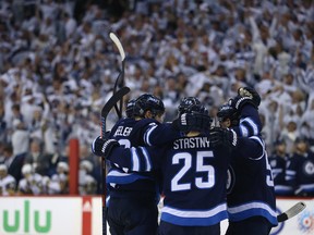 Jets’ Mark Scheifele (left) congratulates defenceman Dustin Byfuglien on his goal against the Vegas Golden Knights during Game 1 of their Western Conference final on Saturday night in Winnipeg. (KEVIN KING/WINNIPEG SUN)