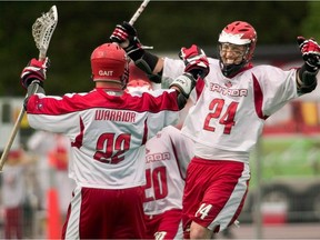 Canada's Gary Gait (left) and John Grant Jr. celebrate a goal during the final quarter of their win over the United States at the World Lacrosse Championships in London, Ont. Saturday July 22, 2006. The Canadian Lacrosse Association broke off communication with the National Lacrosse Team Players' Association on Monday, deepening a standoff that is endangering Canada's participation in the upcoming men's field lacrosse world championship.