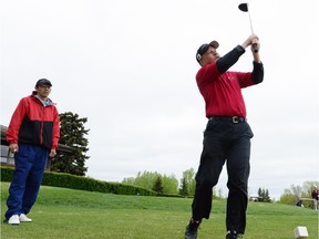 REGINA, SK: MAY 30, 2013 -- Blind golfer Gerry Nelson (R) tees off with the help of Chris Villeneuve at a CNIB fundraiser at the Tor Hill Golf Course near Regina, SK on May 30, 2013.  (Don Healy / Leader-Post) (Story by Ian Hamilton)