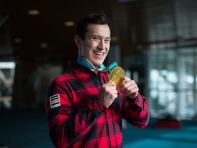 Figure skater Patrick Chan holds his Olympic gold medal after returning to Canada from South Korea earlier this year.