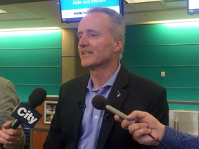 WestJet president and CEO Ed Sims speaks to reporters at the Calgary International Airport on Friday, May 25, 2018. The airline and the Air Line Pilots Association have agreed to a settlement process that will involve a federal mediator.