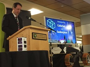 University of Saskatchewan associate professor of engineering Sean Maw, speaks at the announcement introducing the CubeSat (pictured in white on the left) and the "Saskorpian" rover at the U of S in Saskatoon on May 4, 2018. (Erin Petrow/Saskatoon StarPhoenix)